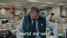 a man in an office with the words burst my vest on his chest