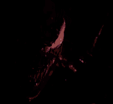 a close up of venom 's face with a purple background