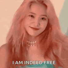 a girl with pink hair is smiling and says i am indeed free