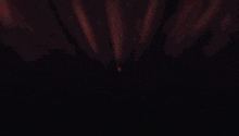 a close up of a person 's face with a light coming out of his mouth .