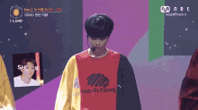 a man wearing a red yellow and black shirt that says outtroublesome