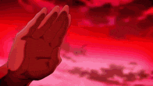 a person 's hand is reaching out in a red background