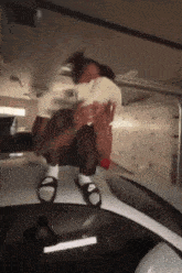 a person is sitting on the roof of a car holding a bunch of money