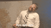 a man in a white shirt and tie holds a baton and says aye aye aye ...