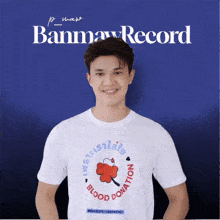 a man wearing a white shirt that says blood donation on it