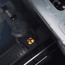 a close up of a robotic arm with a yellow object in front of it