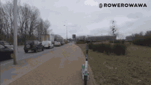 a row of cars are parked on the side of a road with a scooter on the sidewalk