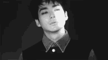 a black and white photo of a young man with his eyes closed and the word cherry in the corner