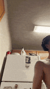 a woman stands in front of a refrigerator that says ireland on it