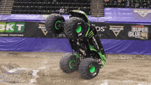 a monster jam monster truck is doing a trick