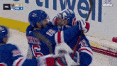 a hockey player with the number 16 on his jersey hugs another player