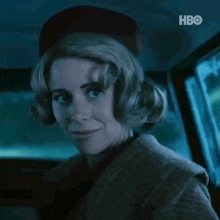 a woman wearing a hat is sitting in a car with hbo written on the bottom