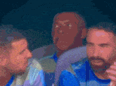 a blurry picture of a man with a beard in a blue shirt