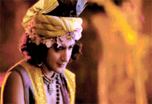 a man wearing a turban with flowers on his head
