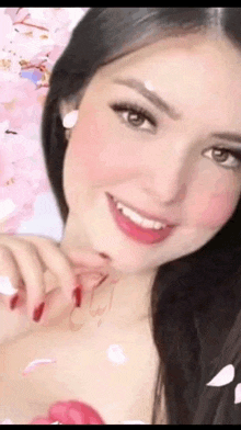 a close up of a woman 's face with petals flying around her