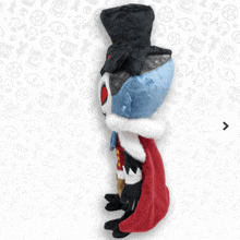 a stuffed animal with a crown and a cape