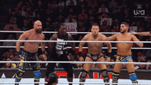 a group of wrestlers are standing in a ring with a sign that says all xiii on it in the background