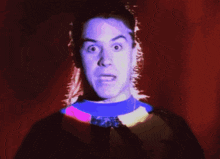 a man with a shocked look on his face holds his head