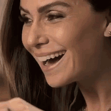 a close up of a woman 's face with her mouth open .