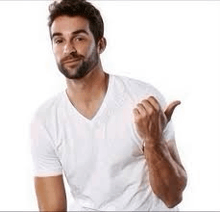 a man with a beard is wearing a white t-shirt and giving a thumbs up sign .