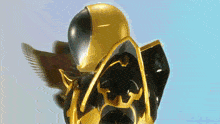 a black and gold robot with a yellow helmet