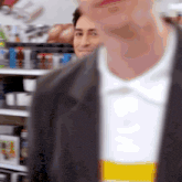 a man wearing a black jacket and a white shirt that says coca cola