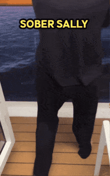 a person walking on a deck with the words " sober sally " on the bottom
