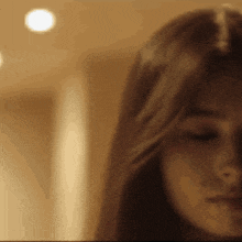 a close up of a woman 's face with a blurred background