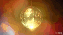 a disco ball hanging from the ceiling with netflix written on the bottom