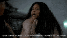a woman in a fur coat is yelling at a man in a car .