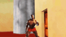 a man in red shorts is standing in a room