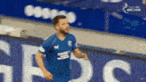 a soccer player wearing a blue jersey that says unibet