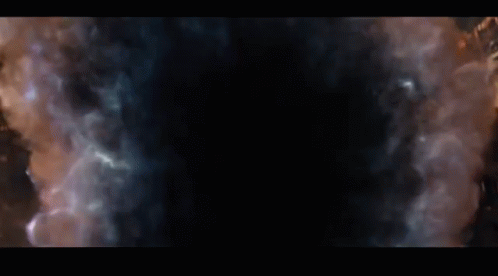 thanos from avengers infinity war is looking at the camera with a beard and a gold vest .