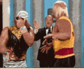hulk hogan and a man in a tuxedo are having a conversation