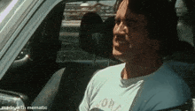 a man is sitting in a car wearing a shirt that says york on it