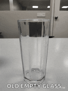 an old empty glass sitting on a table