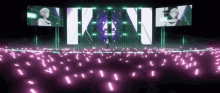 a person is standing in front of a stage with a lot of purple lights .