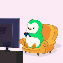 a green and white penguin is sitting in a chair holding a remote control