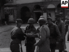 a black and white photo of a group of soldiers with ap written on the bottom right