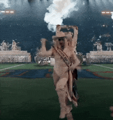 a woman in a cowboy costume is dancing on a stage