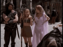a woman in a pink dress is standing next to a man