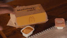 a box of mcdonald 's chicken fingers with creamy chili dipping sauce