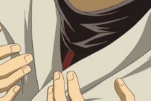 a close up of a person tying a tie with a red stripe