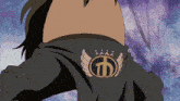 a person wearing a black shirt with a crown and wings on it