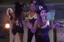 a woman with a prosthetic leg is dancing with two other women in costume