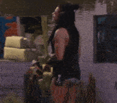 a woman with dreadlocks is standing in the water