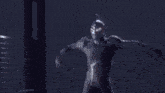 a person is standing in a dark room with a light coming out of their hand .