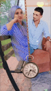 a man and a woman are sitting on a bench with a clock hanging from a chain