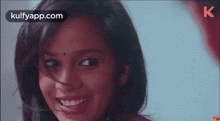 a close up of a woman 's face with the words kulfyapp.com at the bottom