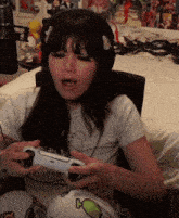 a woman wearing headphones is holding a game controller with the word home on it